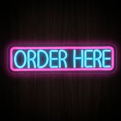 Order Here LED Neon Sign featuring bright blue ORDER HERE lettering with a pink neon rectangular border on clear acrylic.