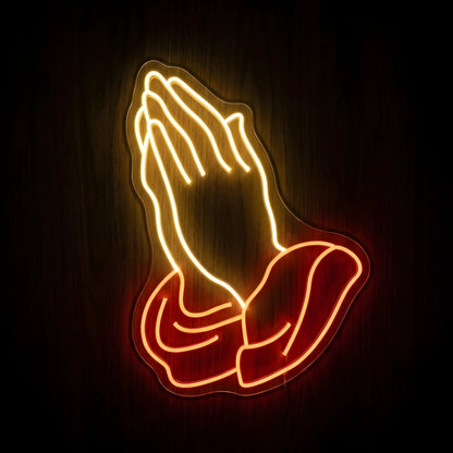Praying Hands LED neon sign featuring warm golden illuminated praying hands with red sleeves on a precision-cut clear acrylic backing for Christian wall decor.