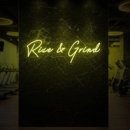  'Rise & Grind' neon sign glowing in lemon yellow against a styled interior wall.