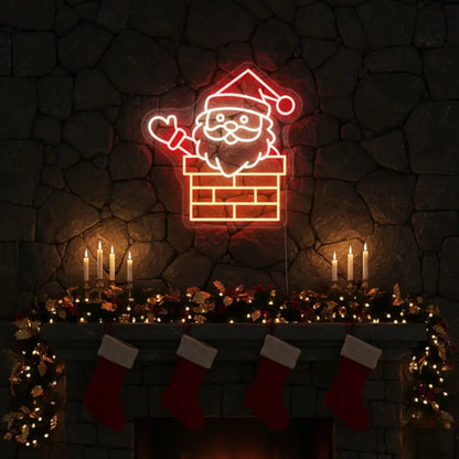 Photo of the 'Santa in Chimney' neon sign glowing in multicolor against a styled interior wall.
