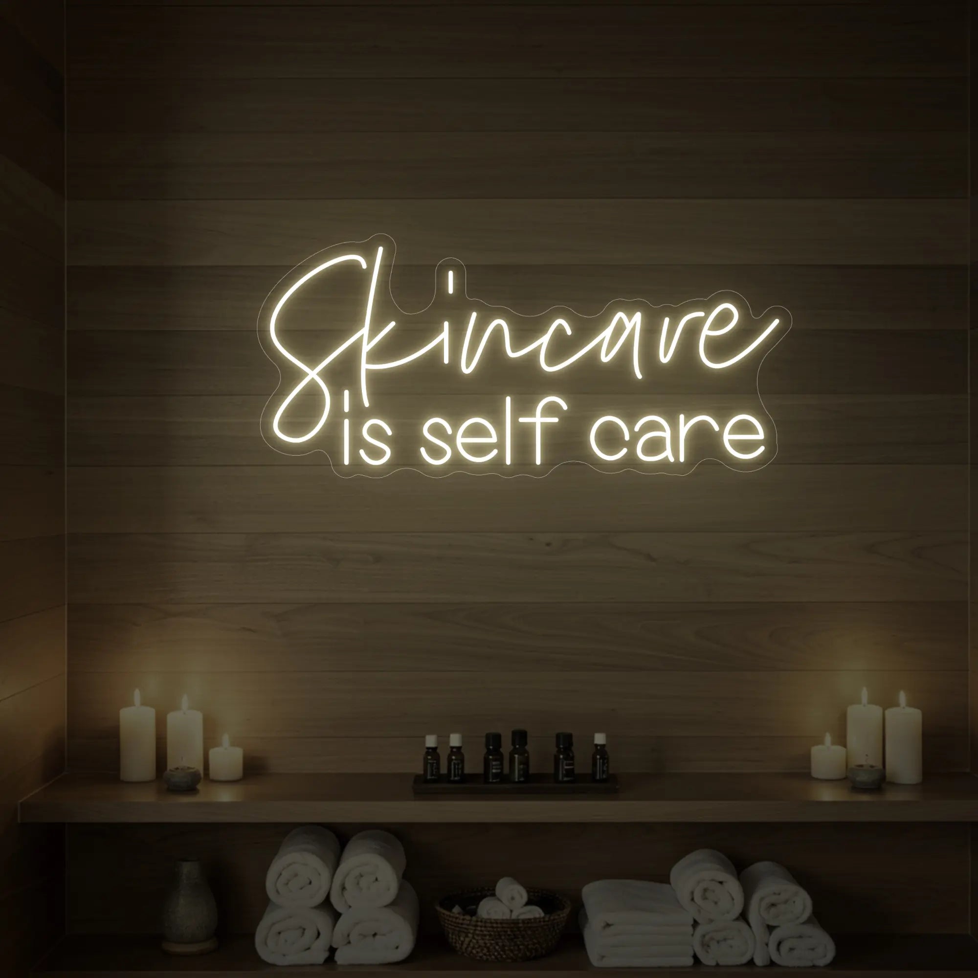 Photo of the 'Skincare is Self Care' neon sign glowing in warm white against a styled interior wall.