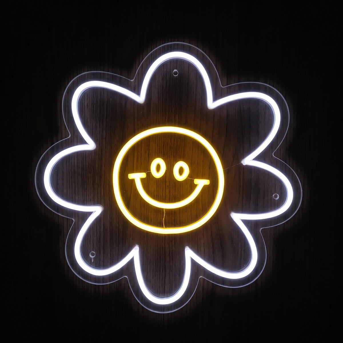 Smiley Daisy LED neon sign with white flower petals and yellow smiling face center on clear acrylic backing.