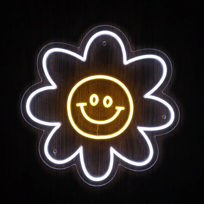 Smiley Daisy LED neon sign with white flower petals and yellow smiling face center on clear acrylic backing.