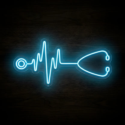 Stethoscope Heartbeat LED Neon Sign featuring a glowing blue stethoscope connected to an ECG heartbeat line on clear cut-to-shape acrylic backing against a dark wooden wall.