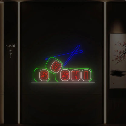 Photo of the 'SUSHI' neon sign glowing in multi-color against a styled interior wall.