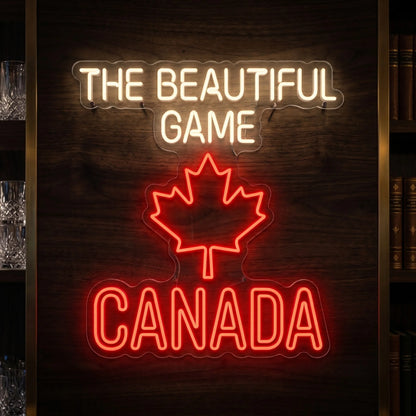 The Beautiful Game Canada LED neon sign featuring a red maple leaf with illuminated football-inspired typography