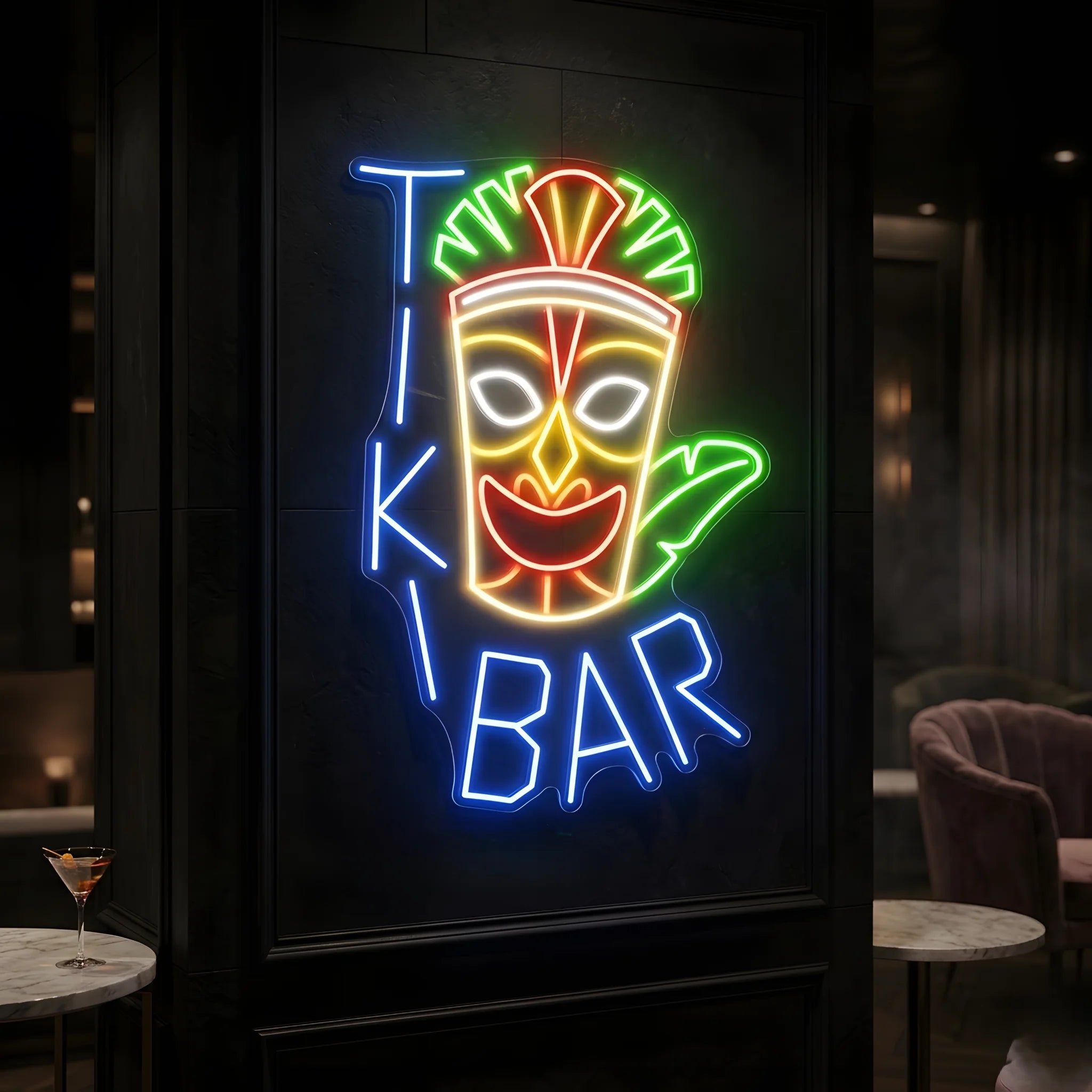 Photo of the 'Tiki Bar' neon sign glowing in multi-color against a tropical tiki-inspired wall.
