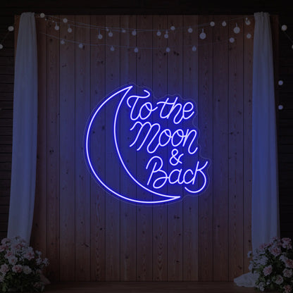  'To The Moon & Back' neon sign glowing in deep blue against a styled interior wall.
