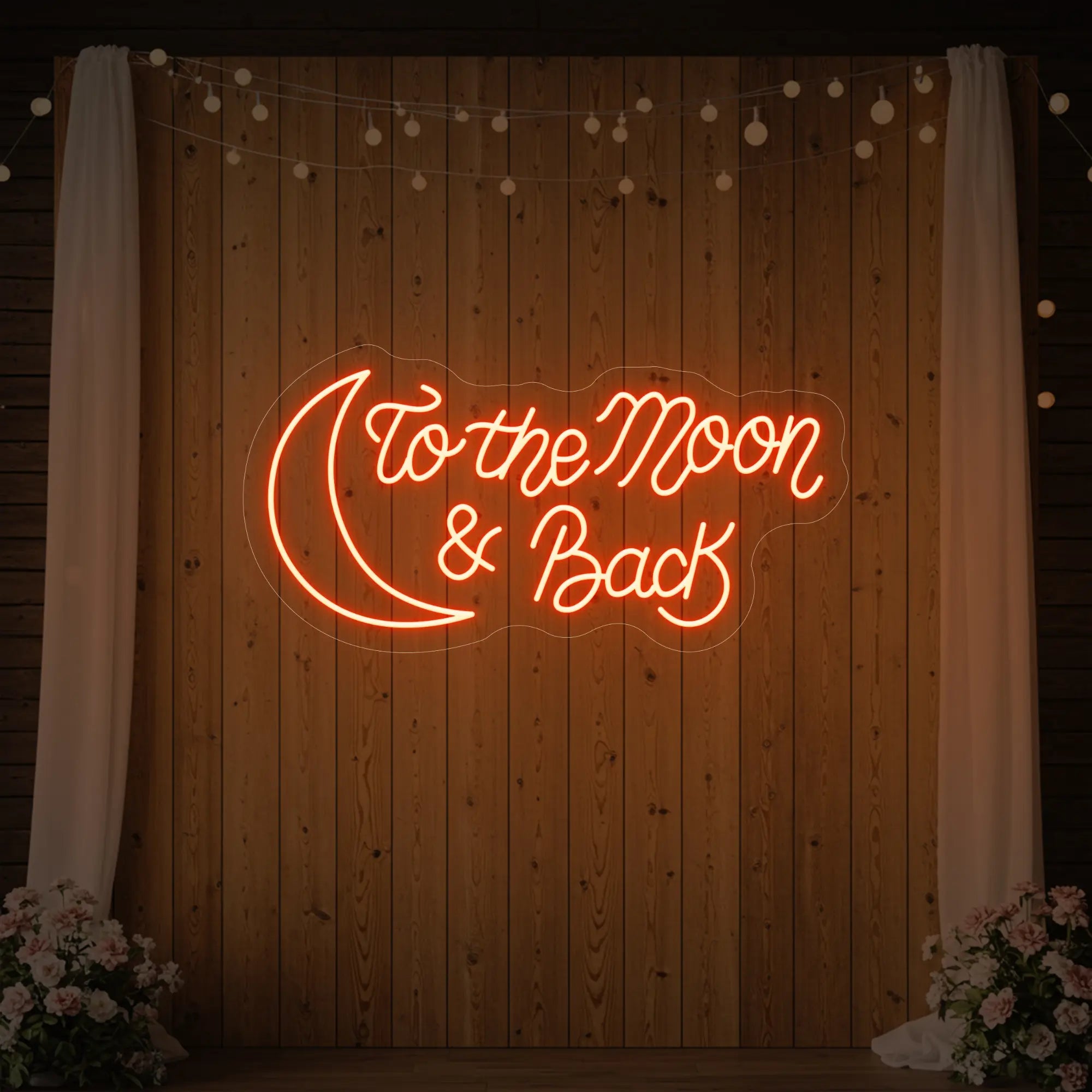  'To The Moon And Back' neon sign glowing in golden yellow against a styled interior wall.