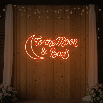  'To The Moon And Back' neon sign glowing in golden yellow against a styled interior wall.