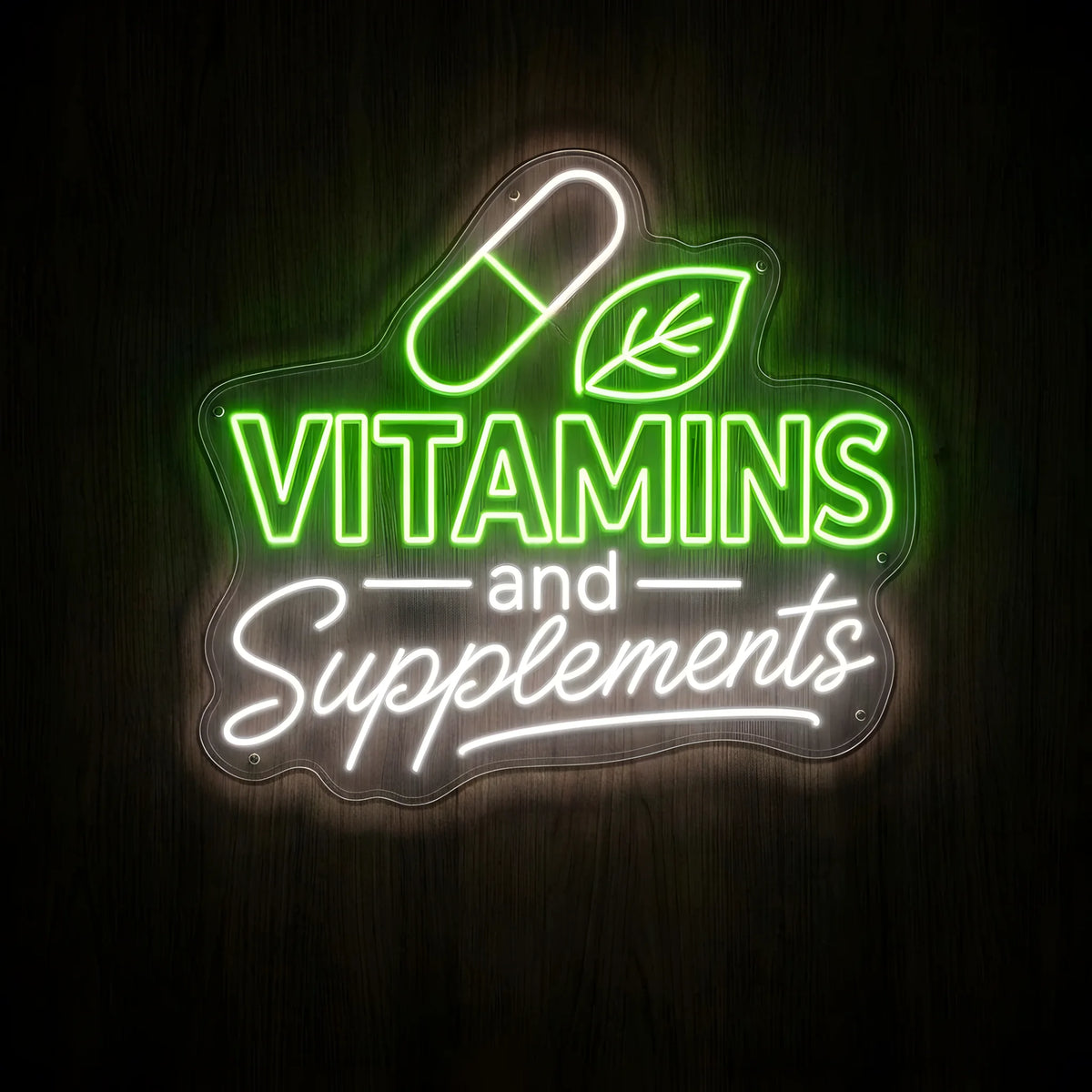 Vitamins and Supplements LED Neon Sign featuring bright green VITAMINS lettering, white cursive Supplements text, and a glowing capsule and leaf illustration on clear acrylic backing against a dark wooden wall.