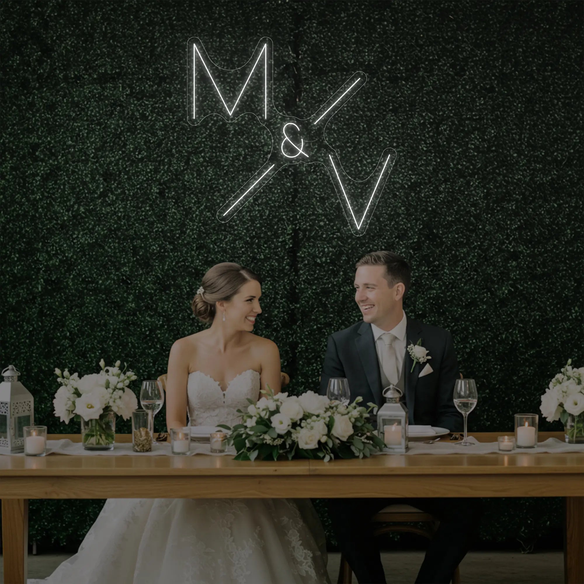 Photo of the 'Wedding Initials Custom Neon Sign V1' neon sign glowing in cool white against a styled interior wall.