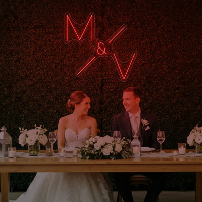 Photo of the 'Wedding Initials Custom Neon Sign V1' neon sign glowing in red against a styled interior wall.