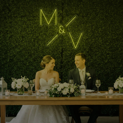 Photo of the 'Wedding Initials Custom Neon Sign V1' neon sign glowing in lemon yellow against a styled interior wall.