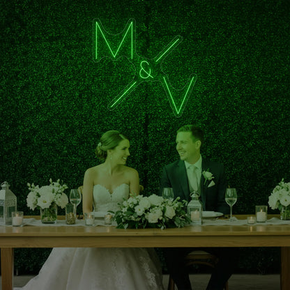 Photo of the 'Wedding Initials Custom Neon Sign V1' neon sign glowing in green against a styled interior wall.