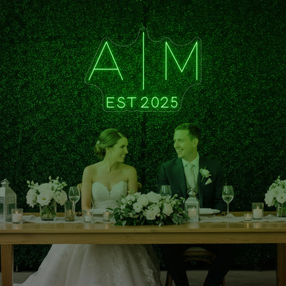 Photo of the 'Wedding Initials Custom Neon Sign V4' neon sign glowing in green against a styled interior wall.