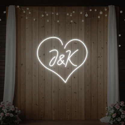Photo of the 'Wedding Initials Custom Neon Sign V5' neon sign glowing in cool white against a styled interior wall.