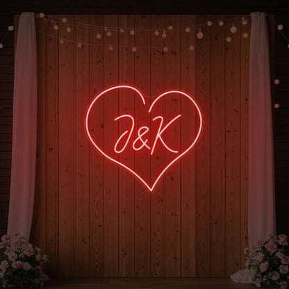 Photo of the 'Wedding Initials Custom Neon Sign V5' neon sign glowing in red against a styled interior wall.