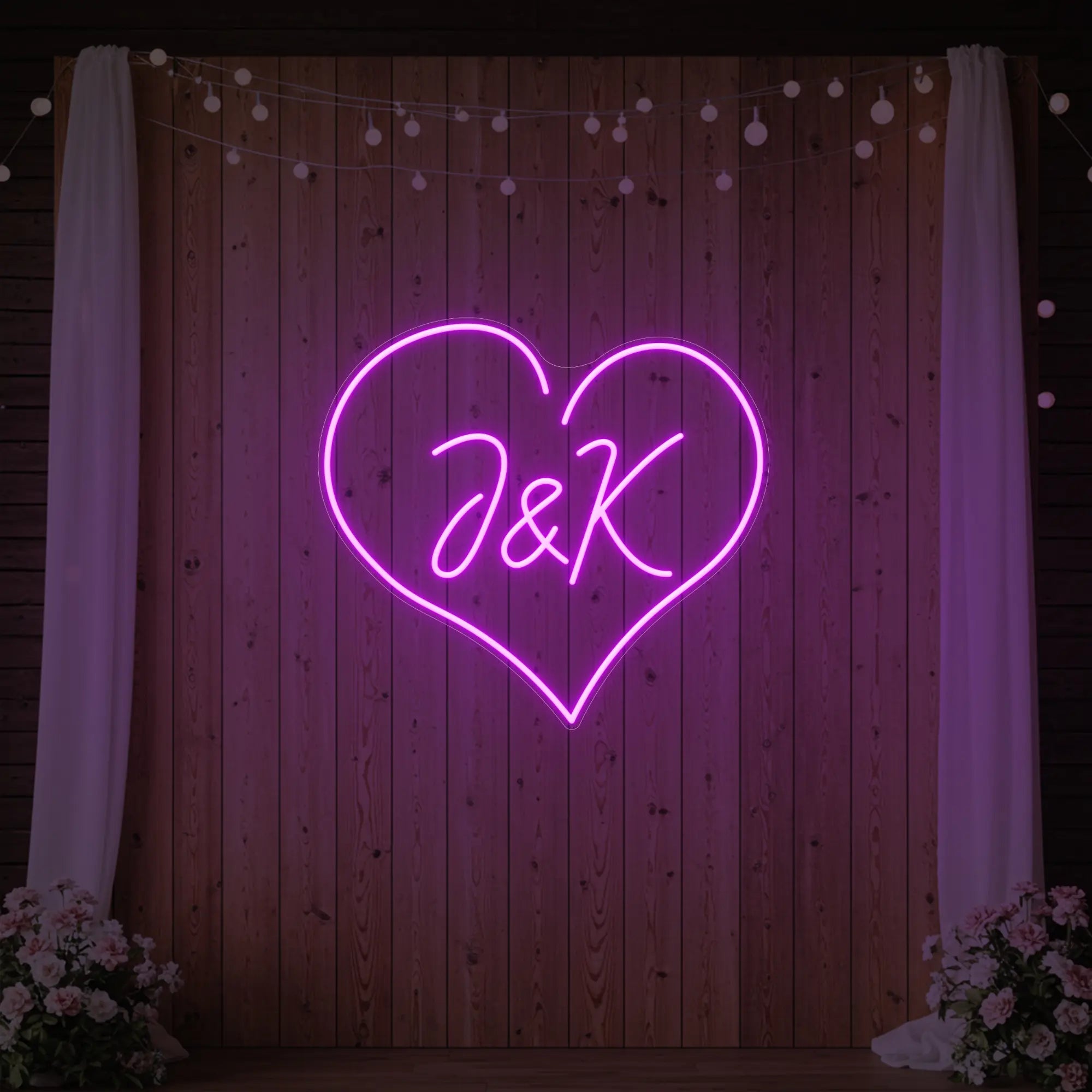 Photo of the 'Wedding Initials Custom Neon Sign V5' neon sign glowing in deep pink against a styled interior wall.
