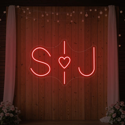 Photo of the 'Wedding Initials Custom Neon Sign V6' neon sign glowing in red against a styled interior wall.