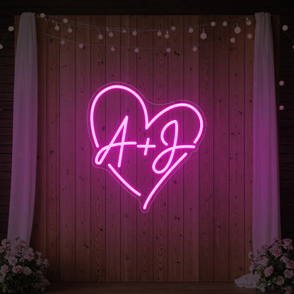 Photo of the 'Wedding Initials Custom Neon Sign V7' neon sign glowing in light pink against a styled interior wall.