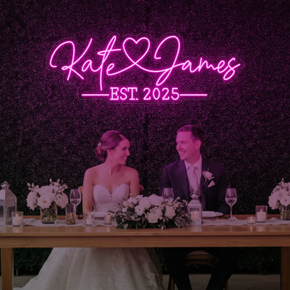 Photo of the 'Wedding Names Custom Neon Sign' neon sign glowing in light pink against a styled interior wall.