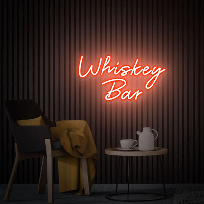 Photo of the 'Whiskey Bar' neon sign glowing in red against a vintage whiskey bar-inspired wall.