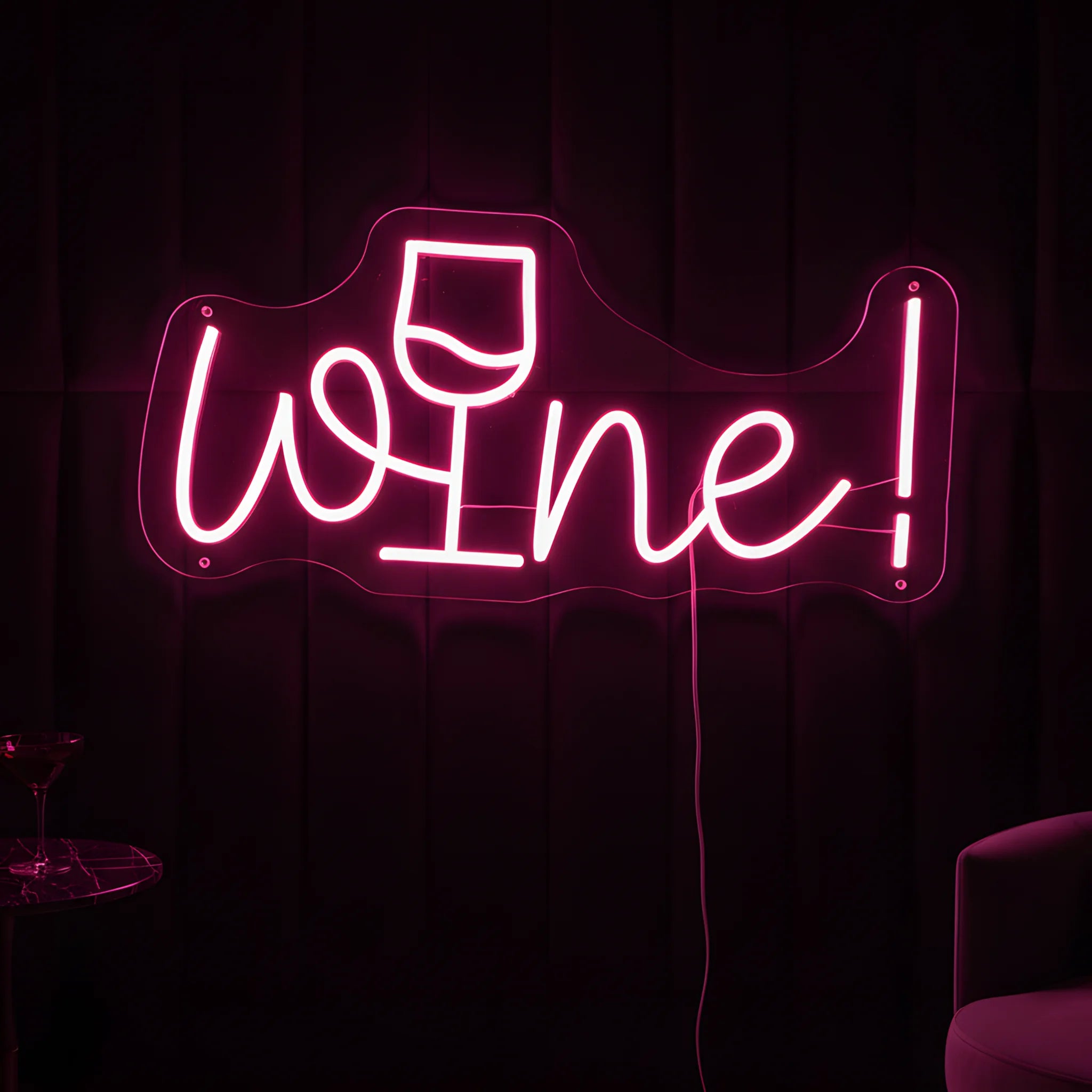 Photo of the 'Wine!' neon sign glowing in pink against a stylish wine bar-inspired wall.