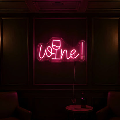Photo of the 'Wine!' neon sign glowing in pink against a stylish wine bar-inspired wall.