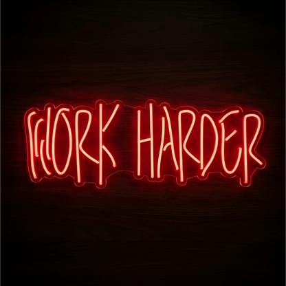 Work Harder LED Neon Sign glowing in red-orange lettering on clear acrylic against a dark wood background, suited to home offices and gym motivation walls.