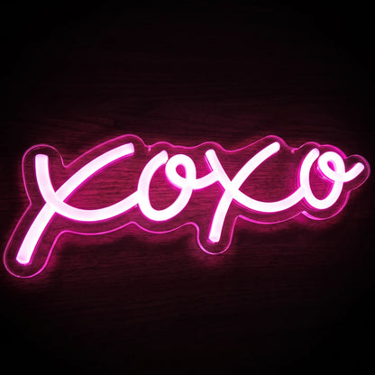 XOXO LED Neon Sign featuring bright pink handwritten-style lettering on a clear acrylic backing.
