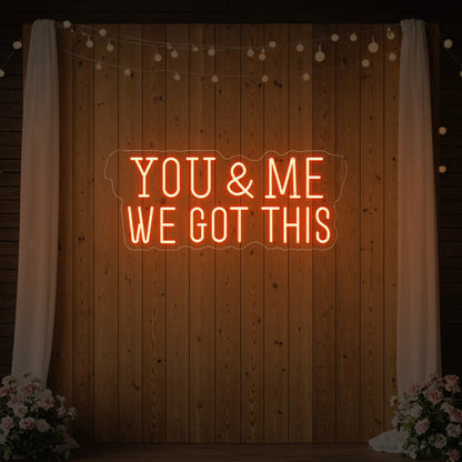 'You & Me We Got This' neon sign glowing in golden yellow against a styled interior wall.