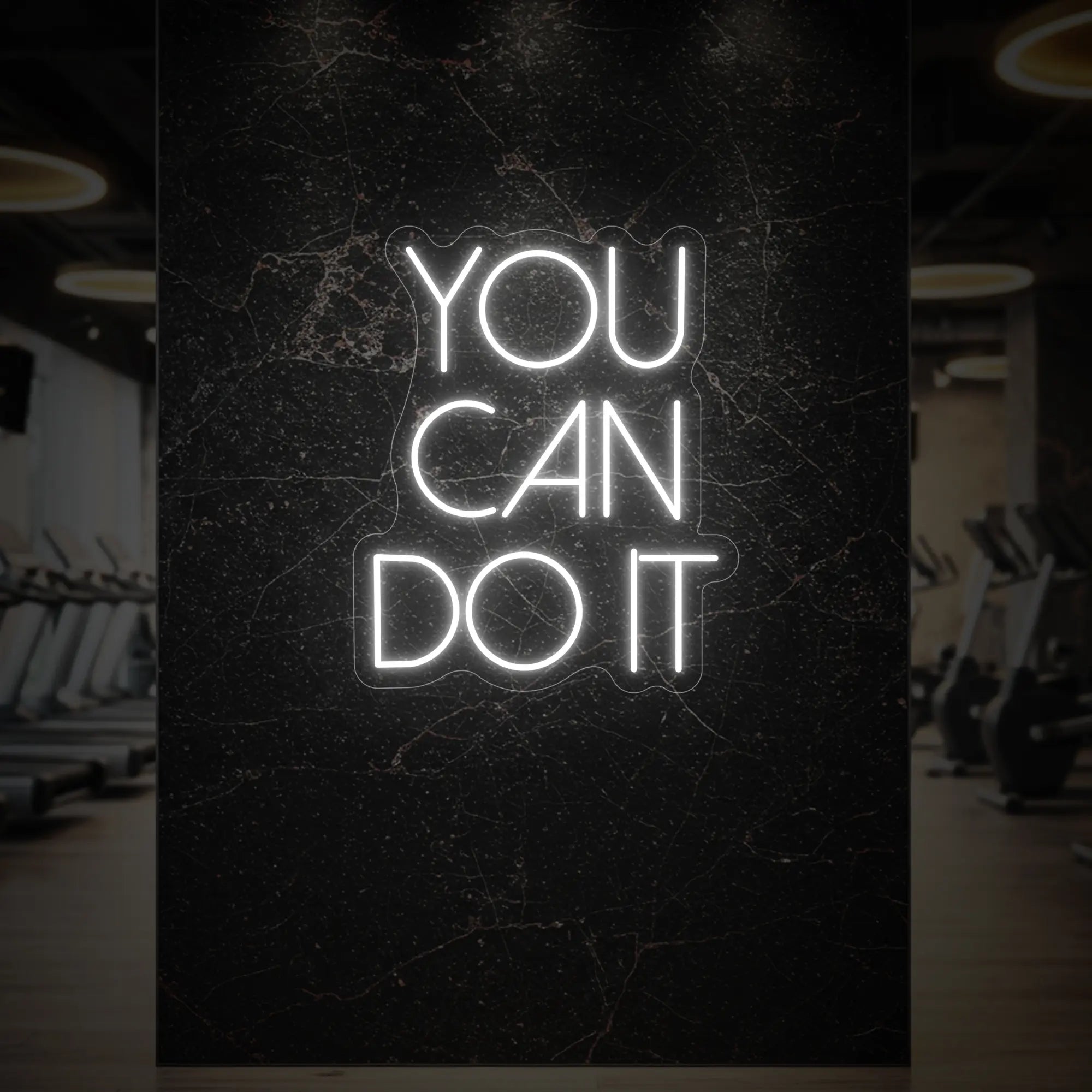  'YOU CAN DO IT' neon sign glowing in cool white against a styled interior wall.