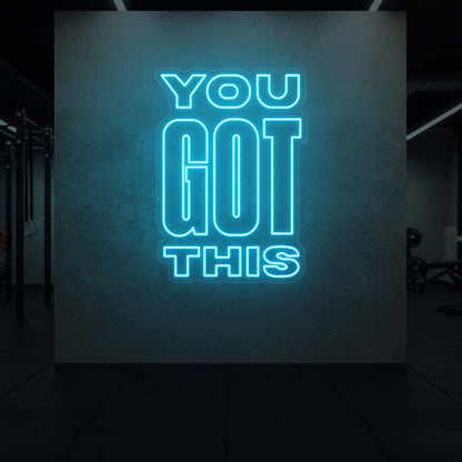 Photo of the 'YOU GOT THIS' neon sign glowing in ice blue against a styled interior wall.