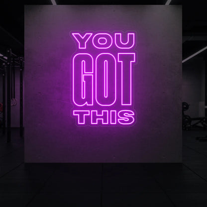Photo of the 'YOU GOT THIS' neon sign glowing in deep pink against a styled interior wall.