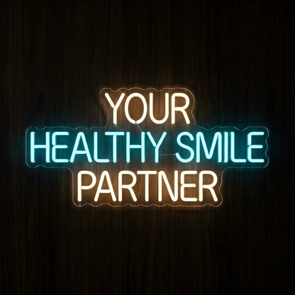 Your Healthy Smile Partner LED neon sign featuring warm white YOUR and PARTNER lettering with bright cyan-blue HEALTHY SMILE text on clear acrylic backing for dental clinic wall decor.