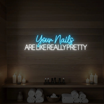 Photo of the 'Your Nails Are Like Really Pretty' neon sign glowing in ice blue against a styled interior wall.

